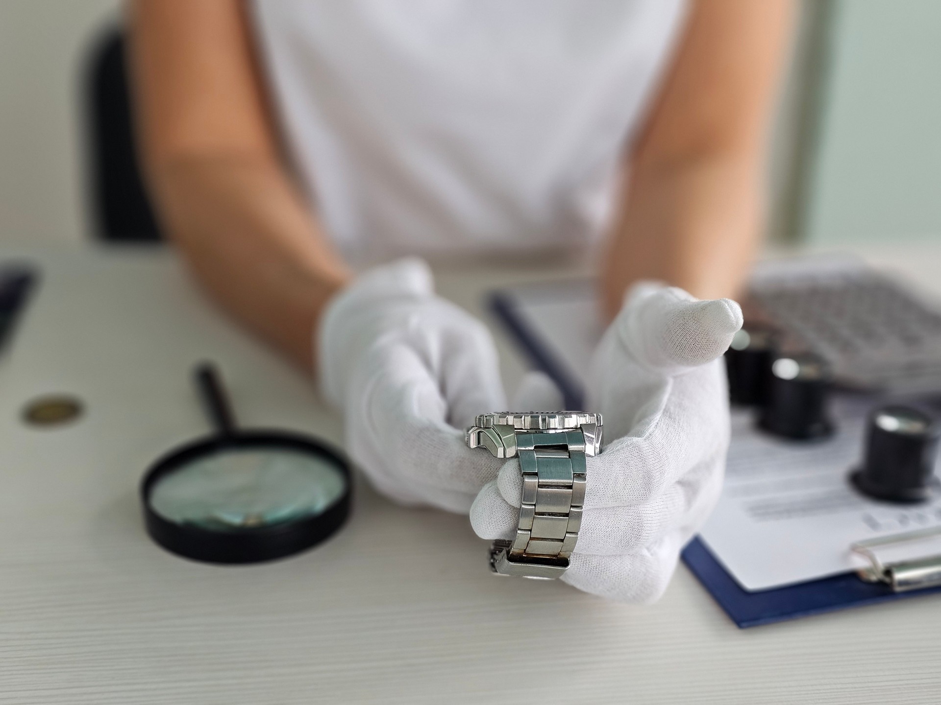 Expert watch technician inspects a luxury watch with precision tools